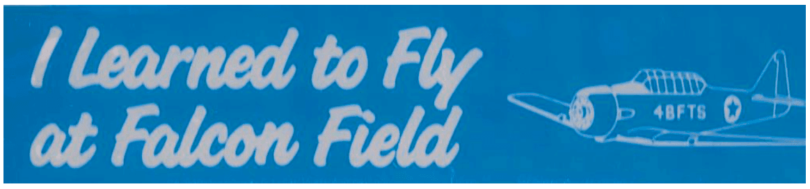 The original blue Falcon Field Association bumper sticker: “I Learned to Fly at Falcon Field” in white script beside a No. 4 BFTS T-6 Texan silhouette.
