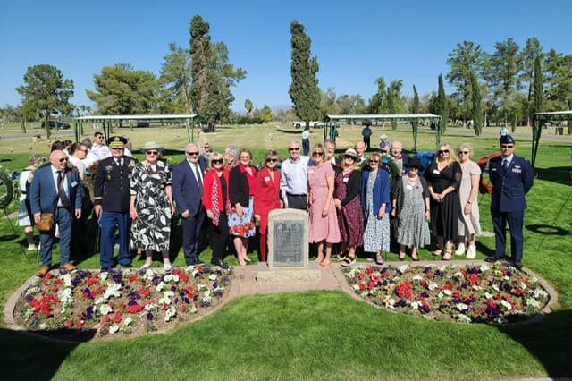 Descendants of the RAF cadets gathered around the cenotaph and its red, white, and blue flower beds.