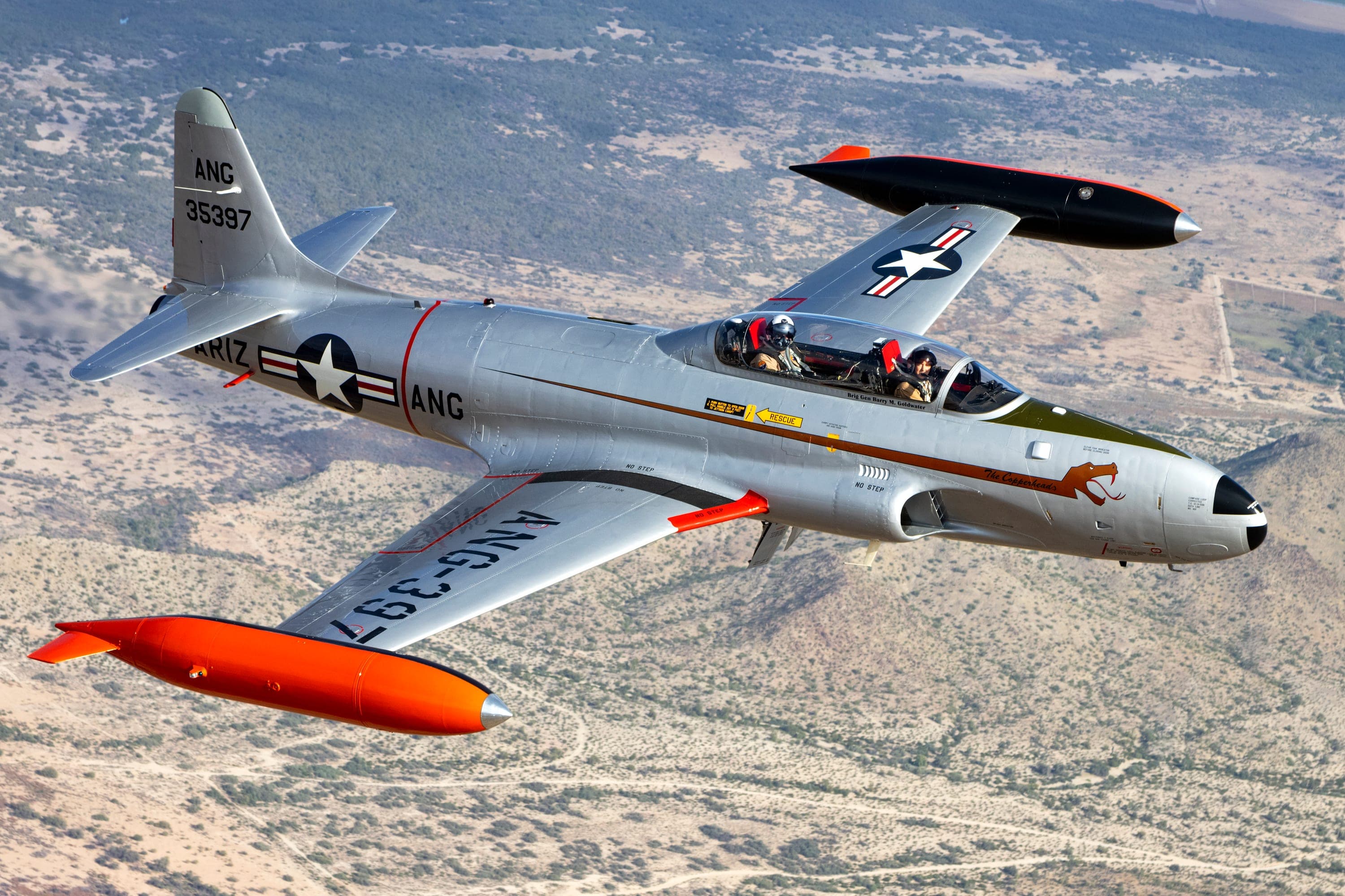 The AAHG T-33 in The Copperheads livery, air-to-air over the Arizona desert.
